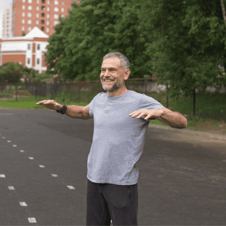 A pre-retiree man stretching at a park